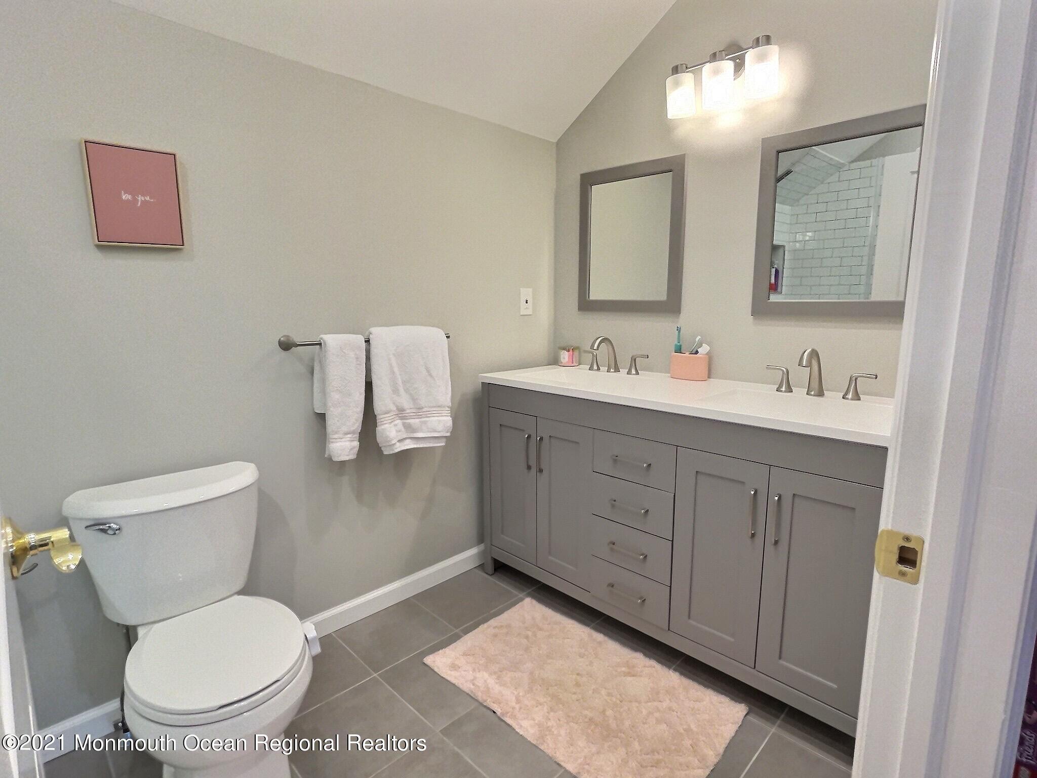 21 Dearborn Drive Holmdel, NJ 07733 - Photo 25 of 48 a bathroom with a toilet sink and mirror