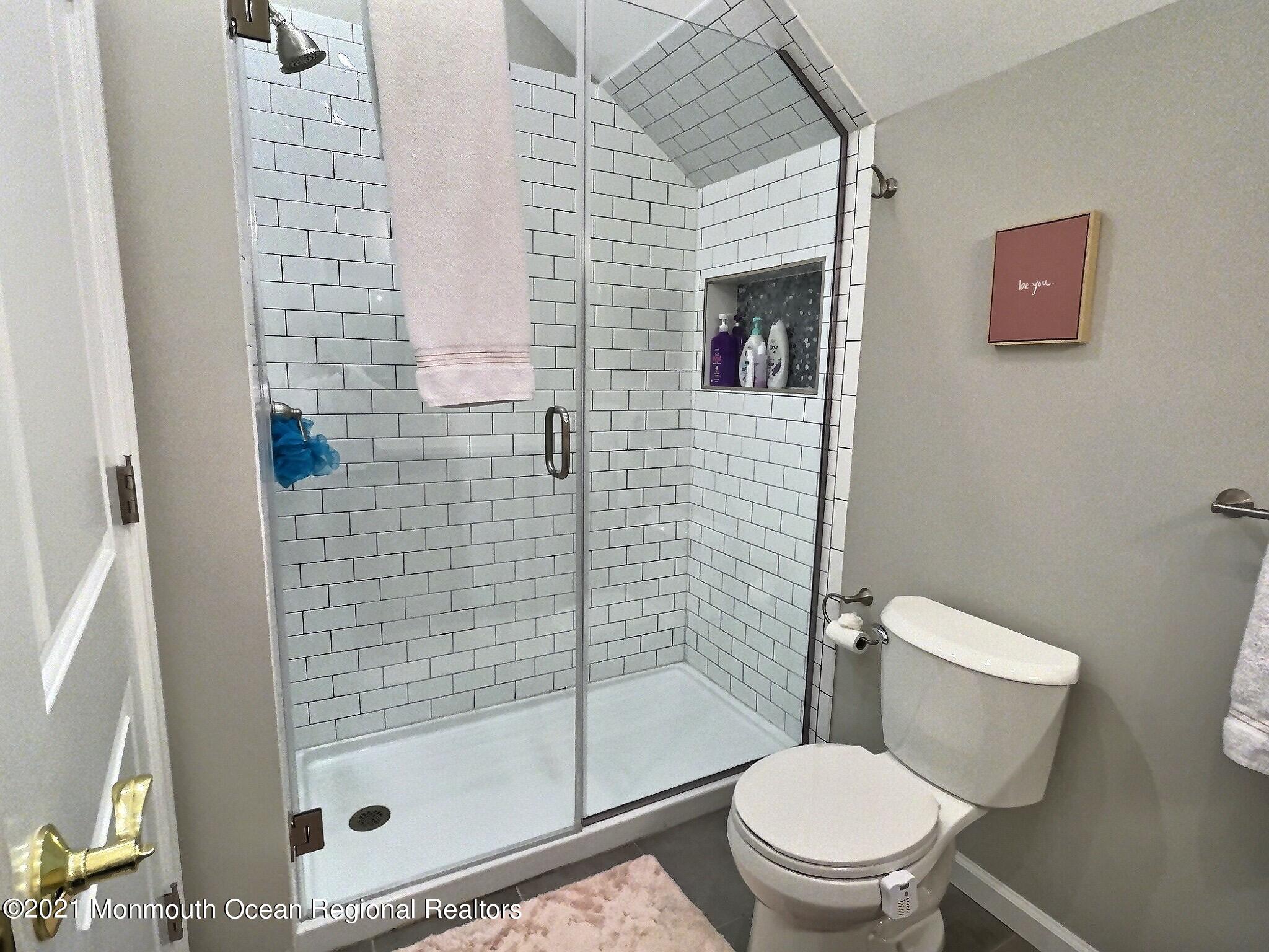 21 Dearborn Drive Holmdel, NJ 07733 - Photo 26 of 48 a white toilet sitting next to a bathroom sink