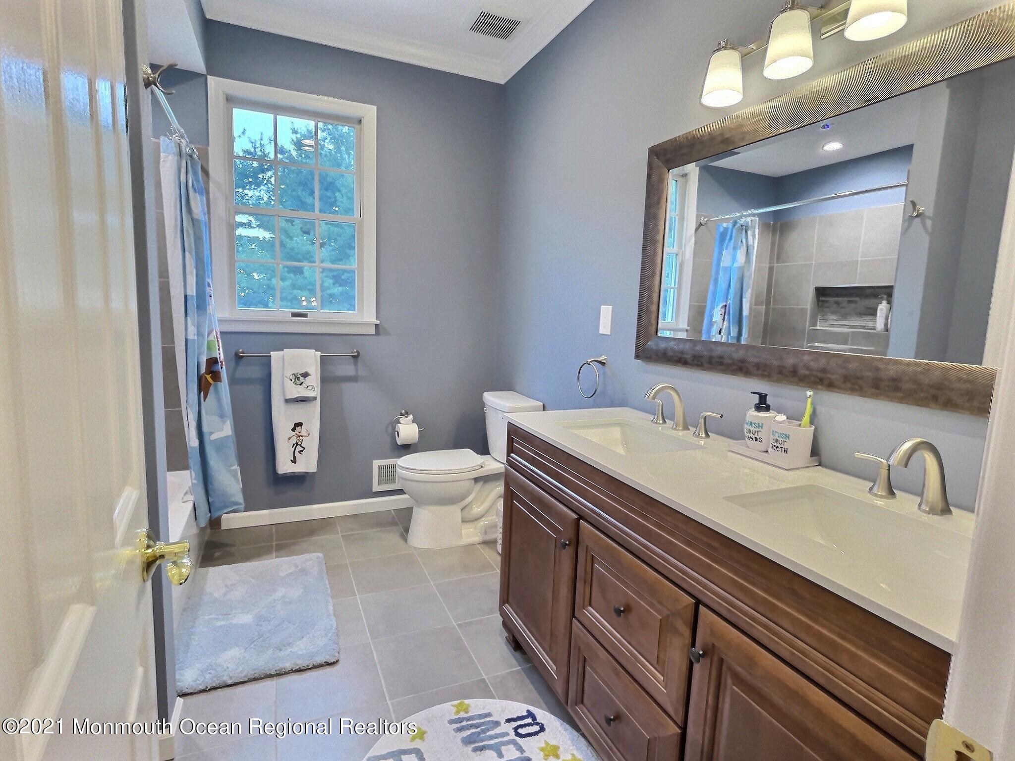 21 Dearborn Drive Holmdel, NJ 07733 - Photo 29 of 48 a spacious bathroom with a granite countertop toilet sink and mirror