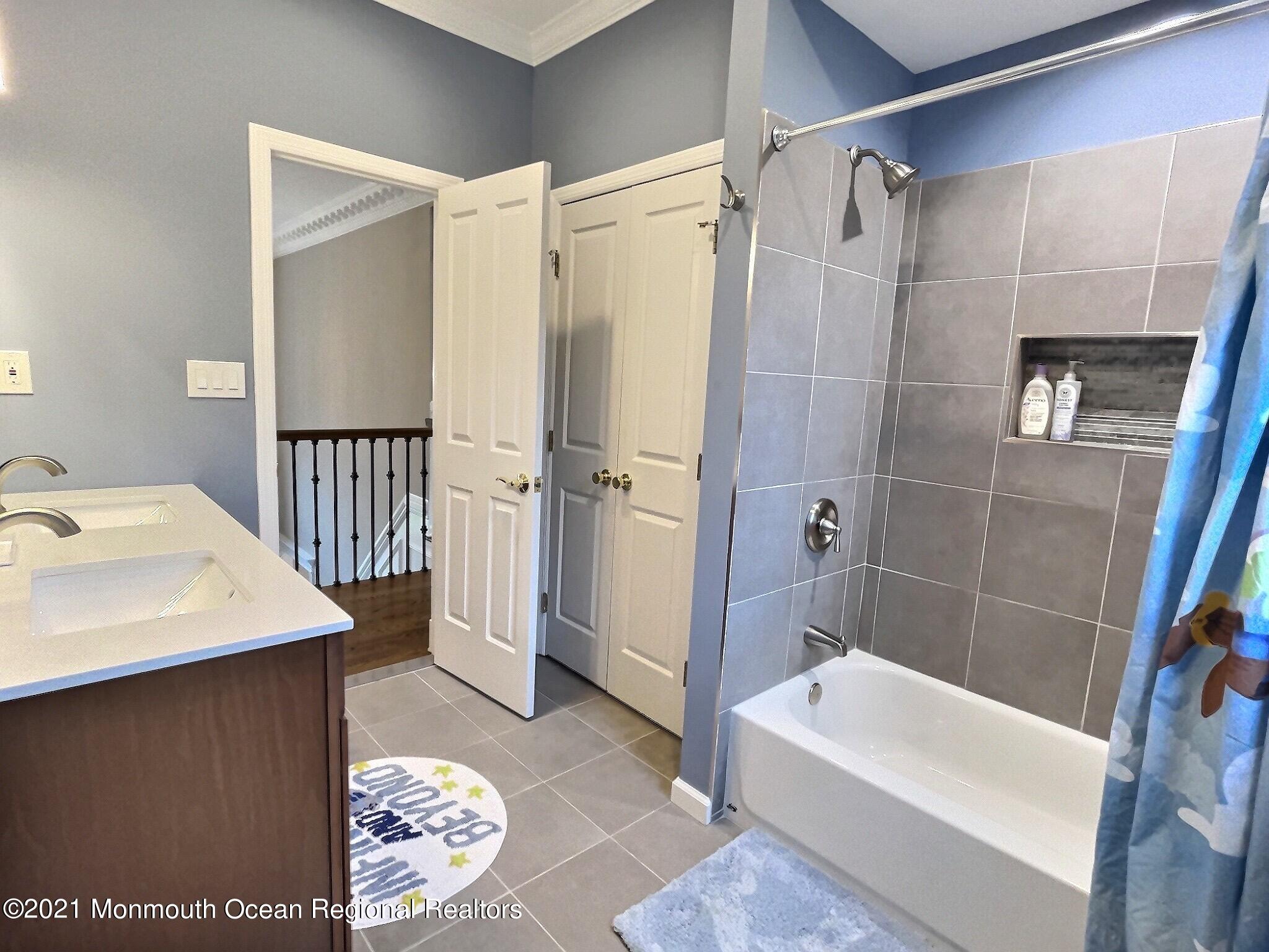 21 Dearborn Drive Holmdel, NJ 07733 - Photo 30 of 48 a bathroom with a sink a toilet and shower