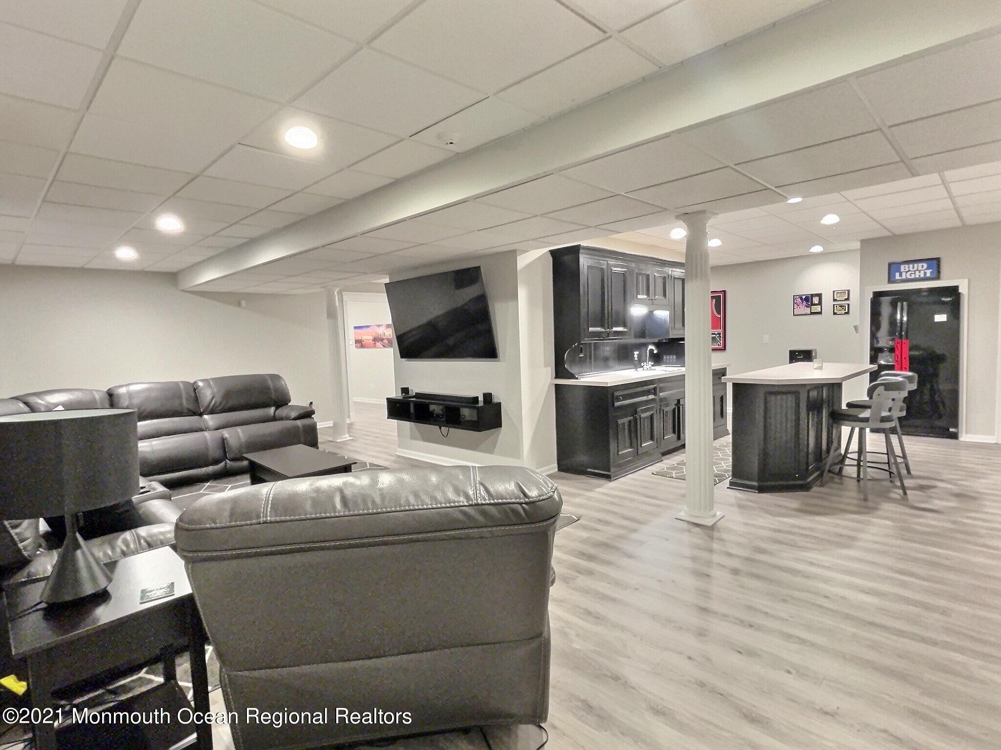 21 Dearborn Drive Holmdel, NJ 07733 - Photo 33 of 48 a living room filled with furniture and a flat screen tv