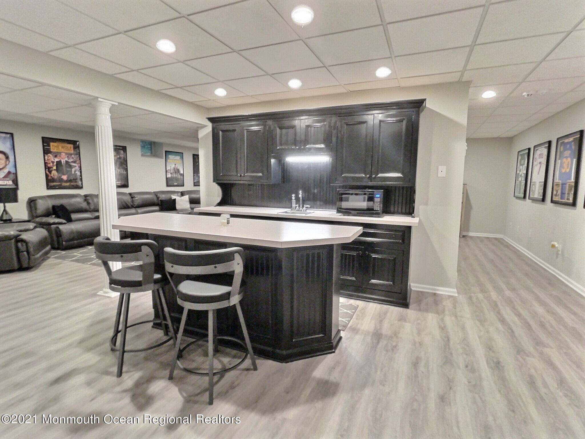 21 Dearborn Drive Holmdel, NJ 07733 - Photo 34 of 48 a kitchen with stainless steel appliances granite countertop a stove a sink a refrigerator dining table and chairs