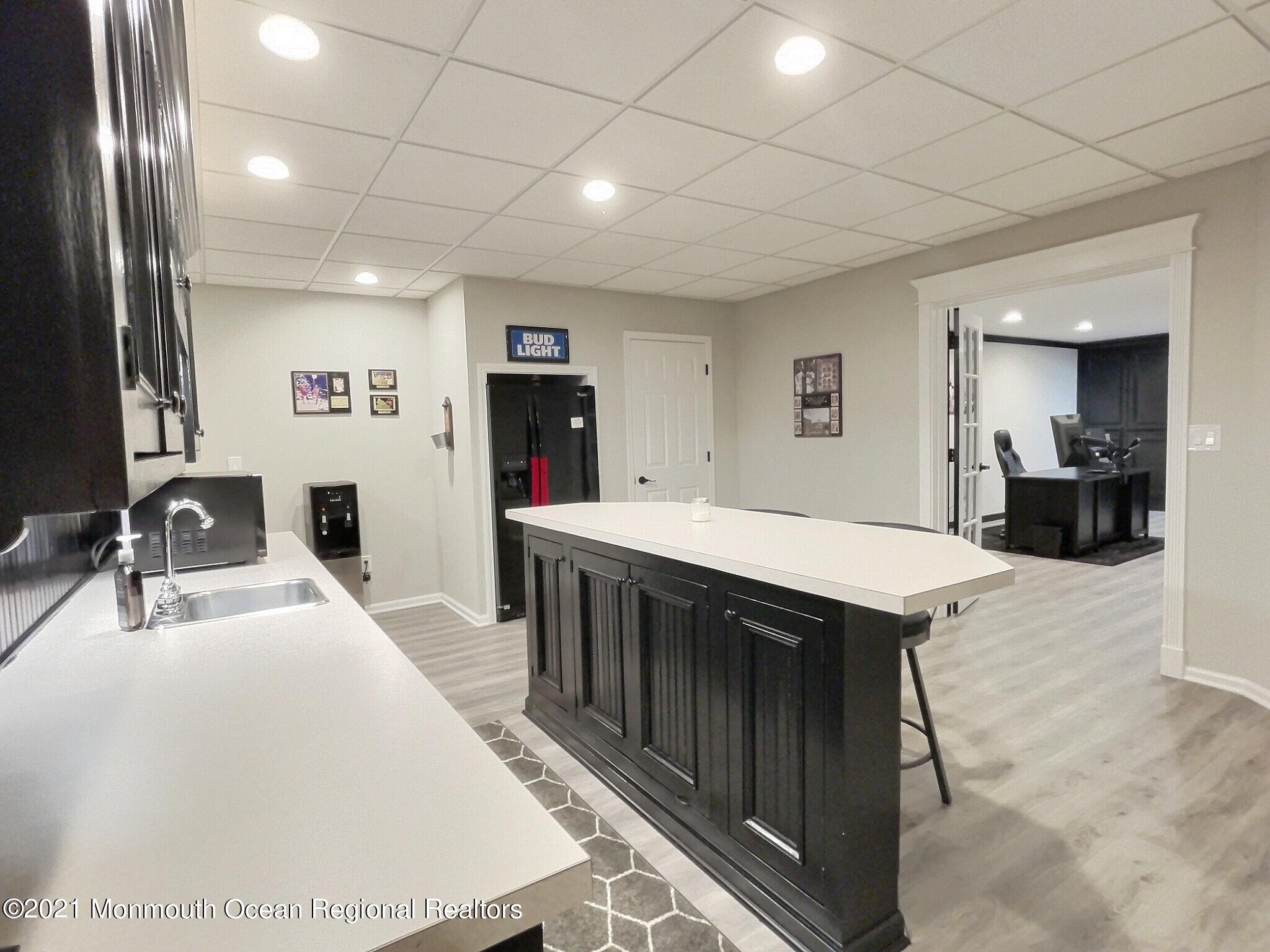 21 Dearborn Drive Holmdel, NJ 07733 - Photo 35 of 48 a kitchen with kitchen island a sink stainless steel appliances dining table and chairs