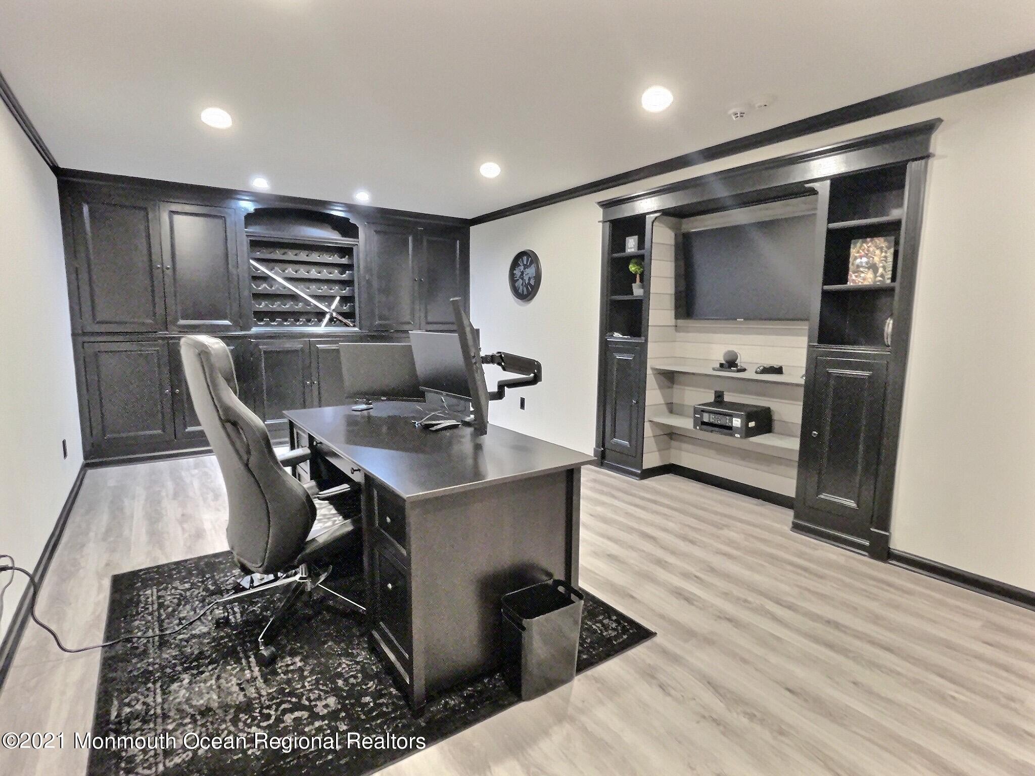 21 Dearborn Drive Holmdel, NJ 07733 - Photo 36 of 48 a kitchen with stainless steel appliances kitchen island granite countertop a sink refrigerator and cabinets