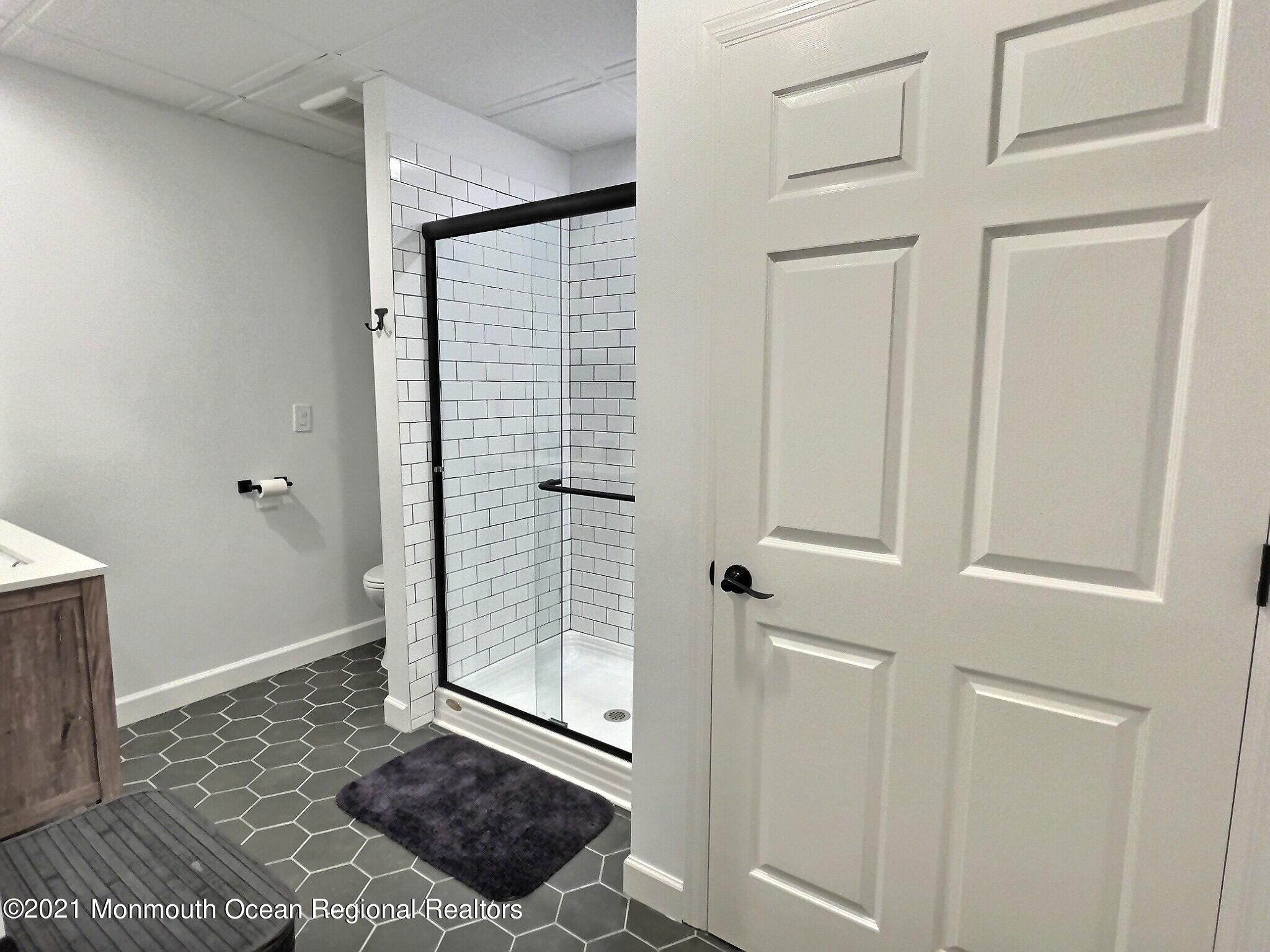 21 Dearborn Drive Holmdel, NJ 07733 - Photo 38 of 48 a view of a bedroom with wooden floor and bathroom