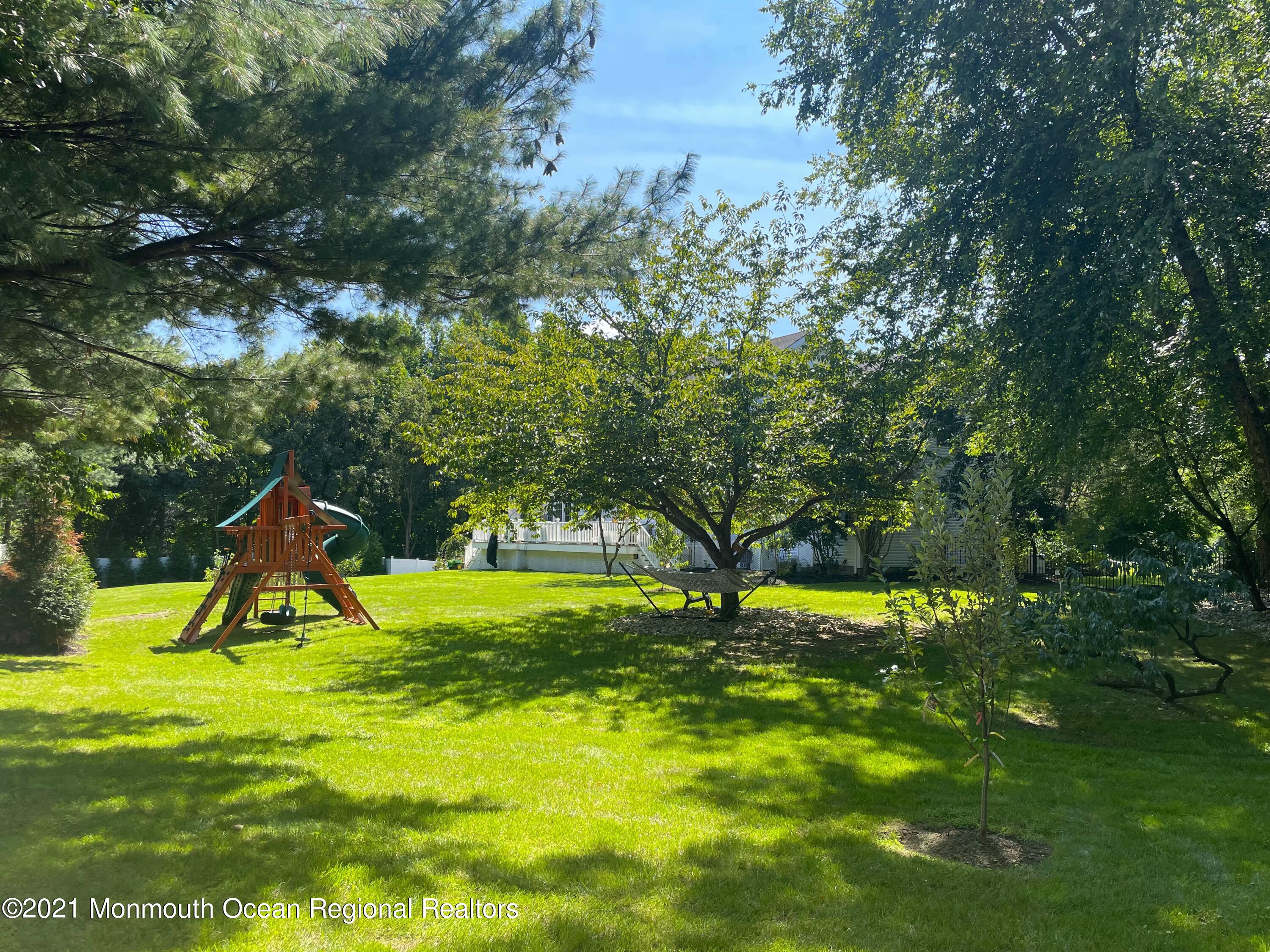 21 Dearborn Drive Holmdel, NJ 07733 - Photo 43 of 48 a view of a backyard with a slide