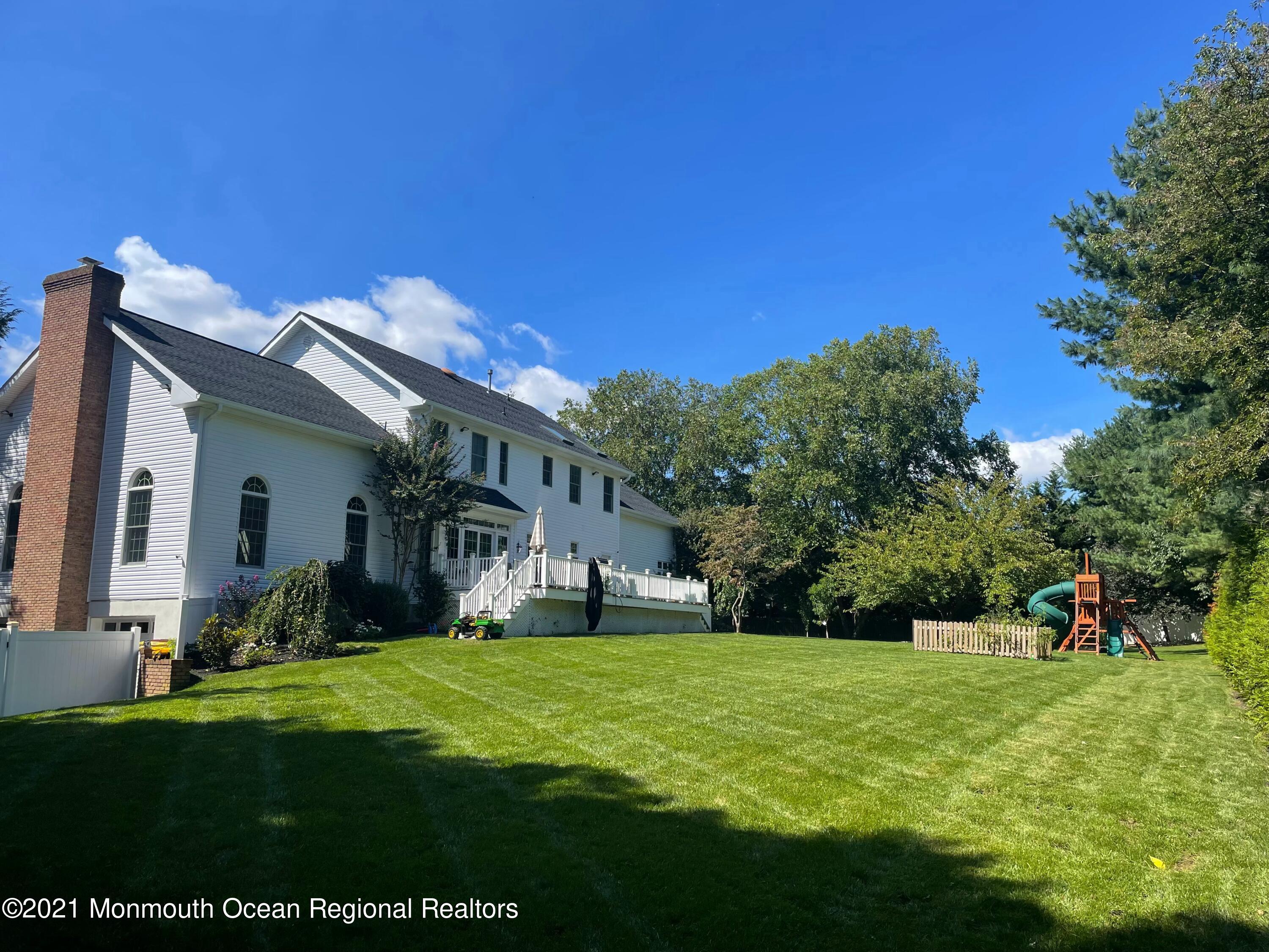 21 Dearborn Drive Holmdel, NJ 07733 - Photo 45 of 48 a view of a house with a big yard potted plants and large tree
