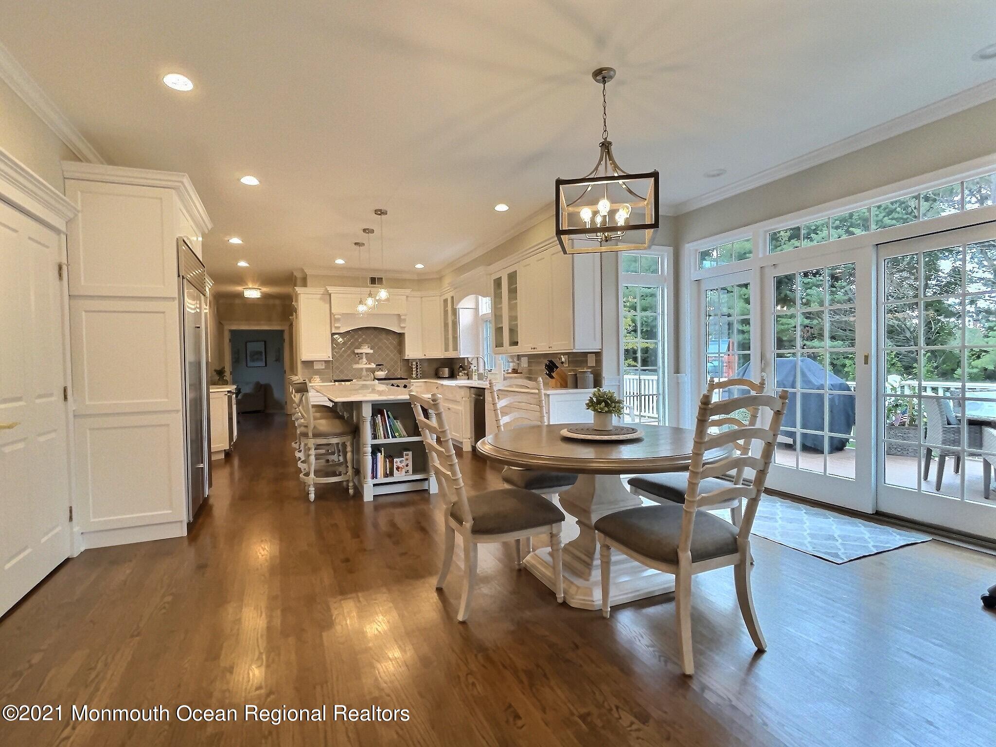 21 Dearborn Drive Holmdel, NJ 07733 - Photo 6 of 48 a view of a dining room with furniture wooden floor and chandelier