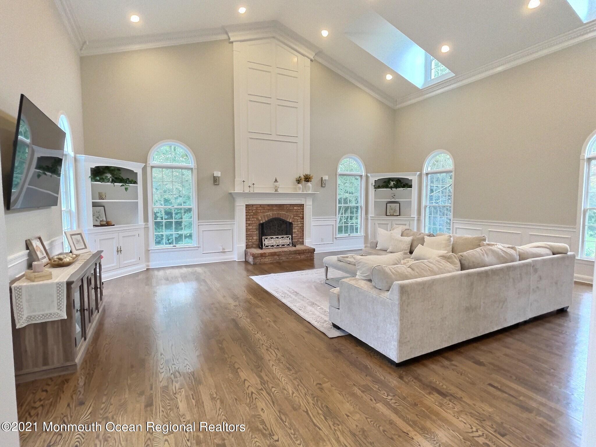 21 Dearborn Drive Holmdel, NJ 07733 - Photo 7 of 48 a living room with furniture and a fireplace