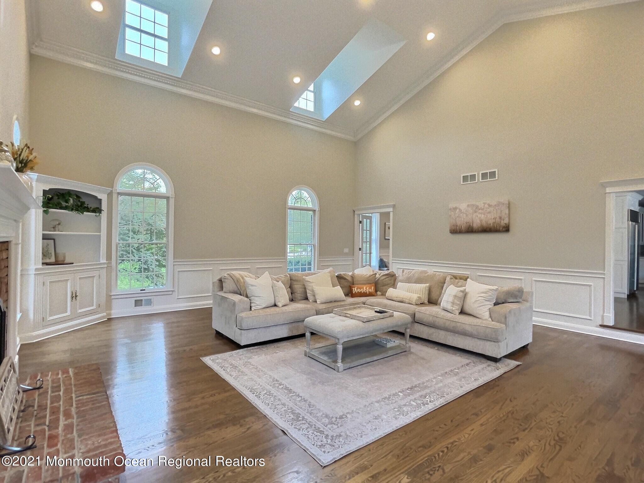 21 Dearborn Drive Holmdel, NJ 07733 - Photo 8 of 48 a living room with furniture and a wooden floor