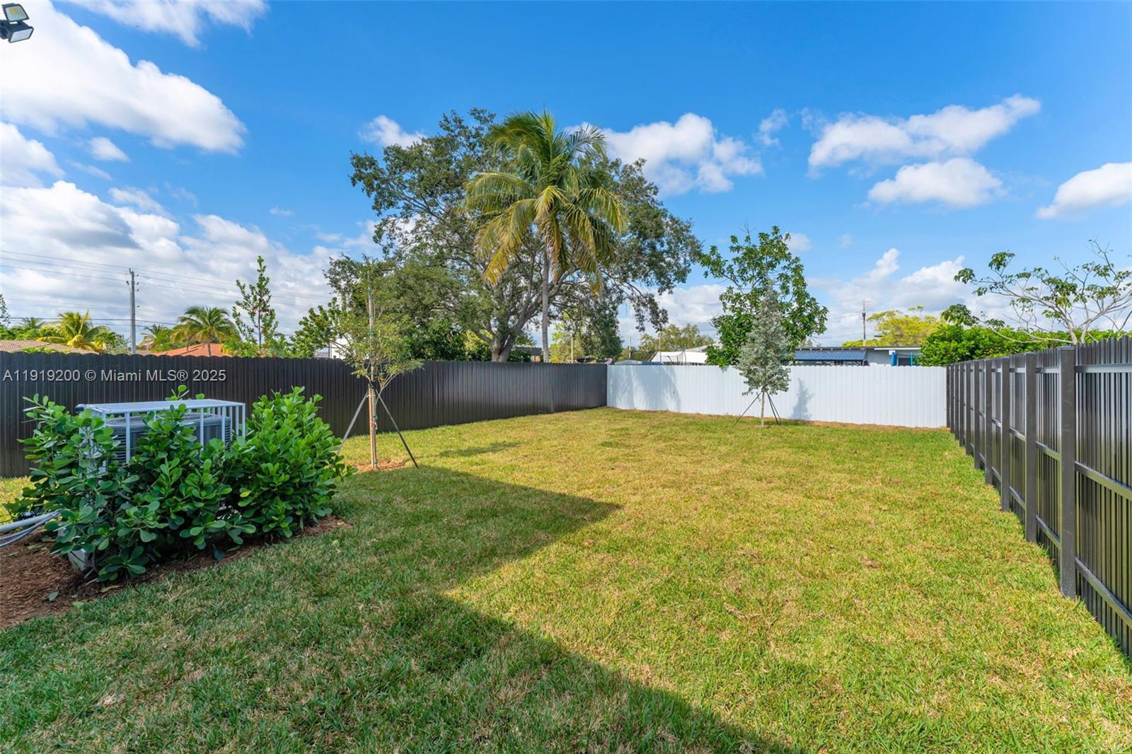 12381 Southwest 220th Street Miami, FL 33170 - Photo 17 of 20 a view of swimming pool with wooden fence