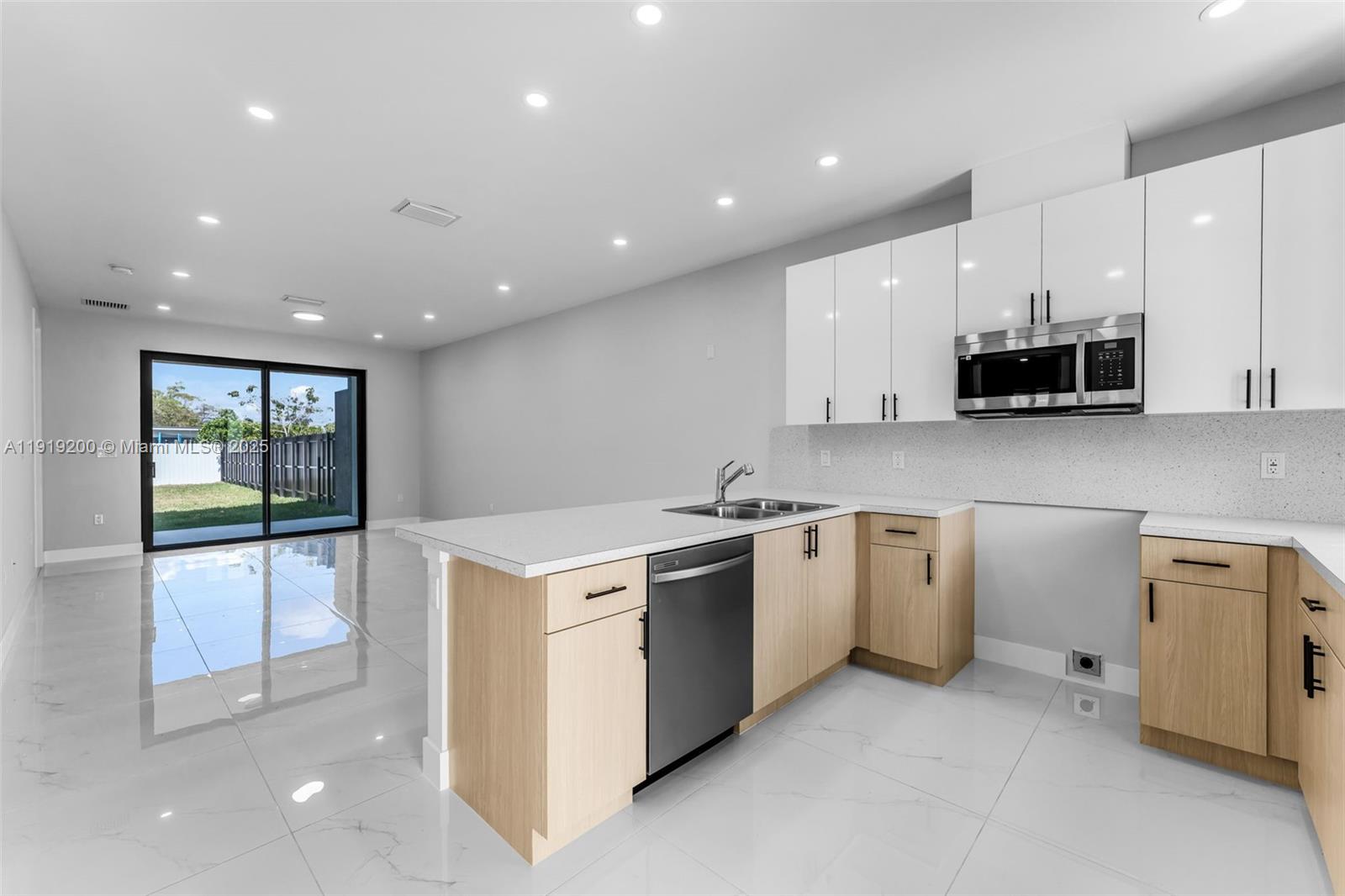 12381 Southwest 220th Street Miami, FL 33170 - Photo 3 of 20 a kitchen with a stove a sink and a refrigerator