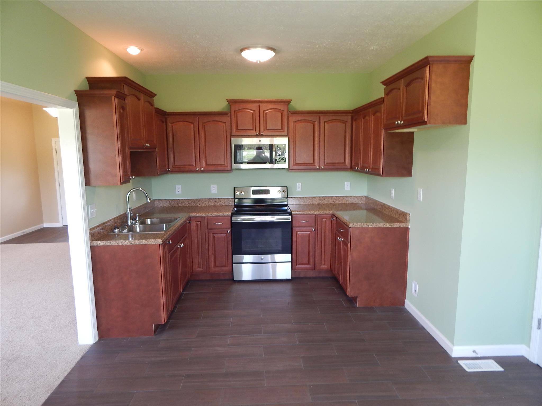 574 Cook Road Portland, TN 37148 - Photo 5 of 12 a kitchen with wooden cabinets and a sink
