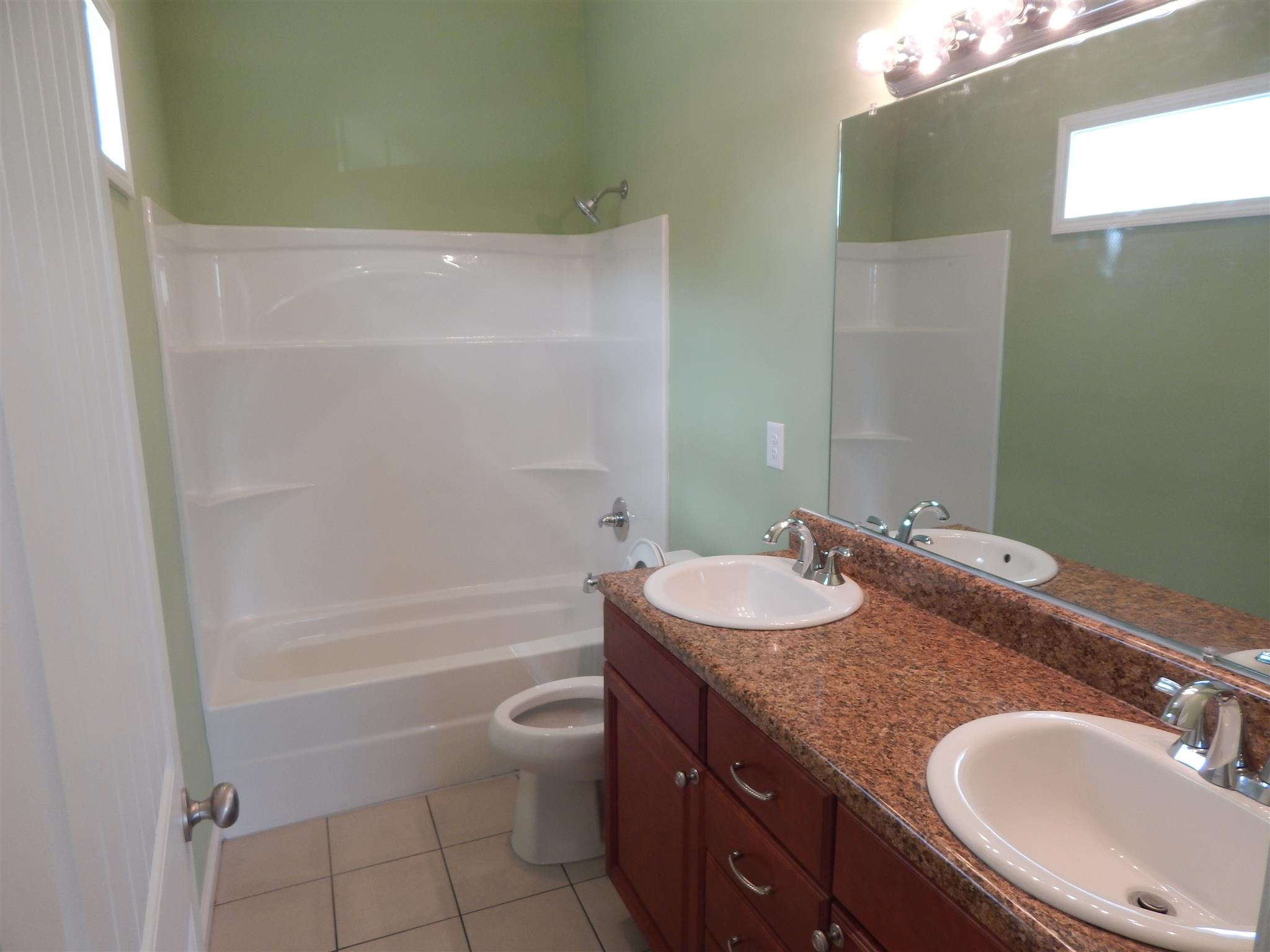 574 Cook Road Portland, TN 37148 - Photo 8 of 12 a bathroom with a granite countertop sink a toilet and bathtub