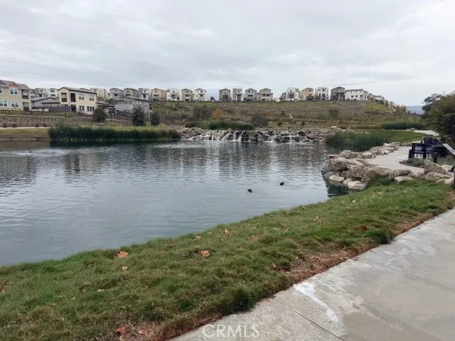 a view of a lake with houses in the back