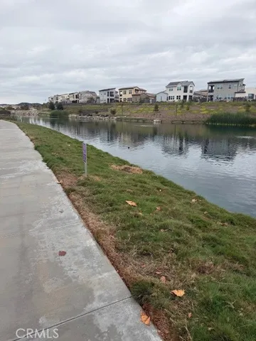 a view of a lake with houses in the back