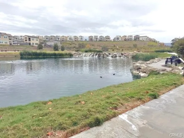 a view of a lake with houses in the back
