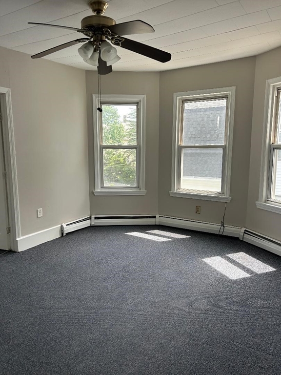 80 Cochran Street, Unit 3L Chicopee, MA 01020 - Photo 7 of 8 an empty room with windows and ceiling fan
