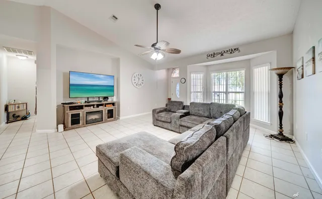 a living room with furniture and a flat screen tv