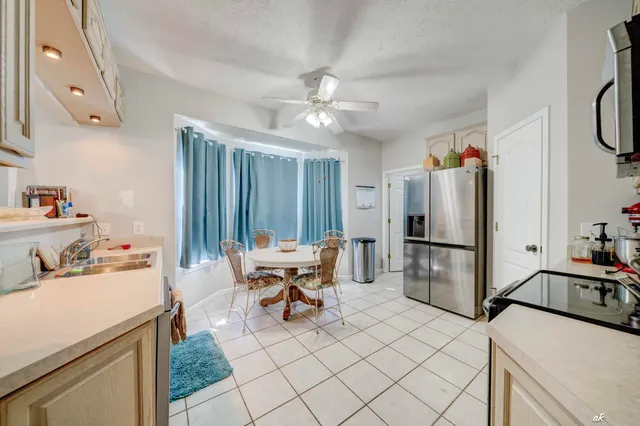 a kitchen with stainless steel appliances a stove a refrigerator and furniture