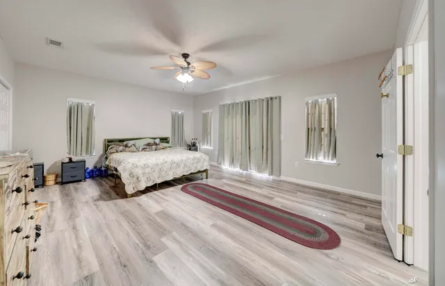 a bedroom with double bed and a chandelier