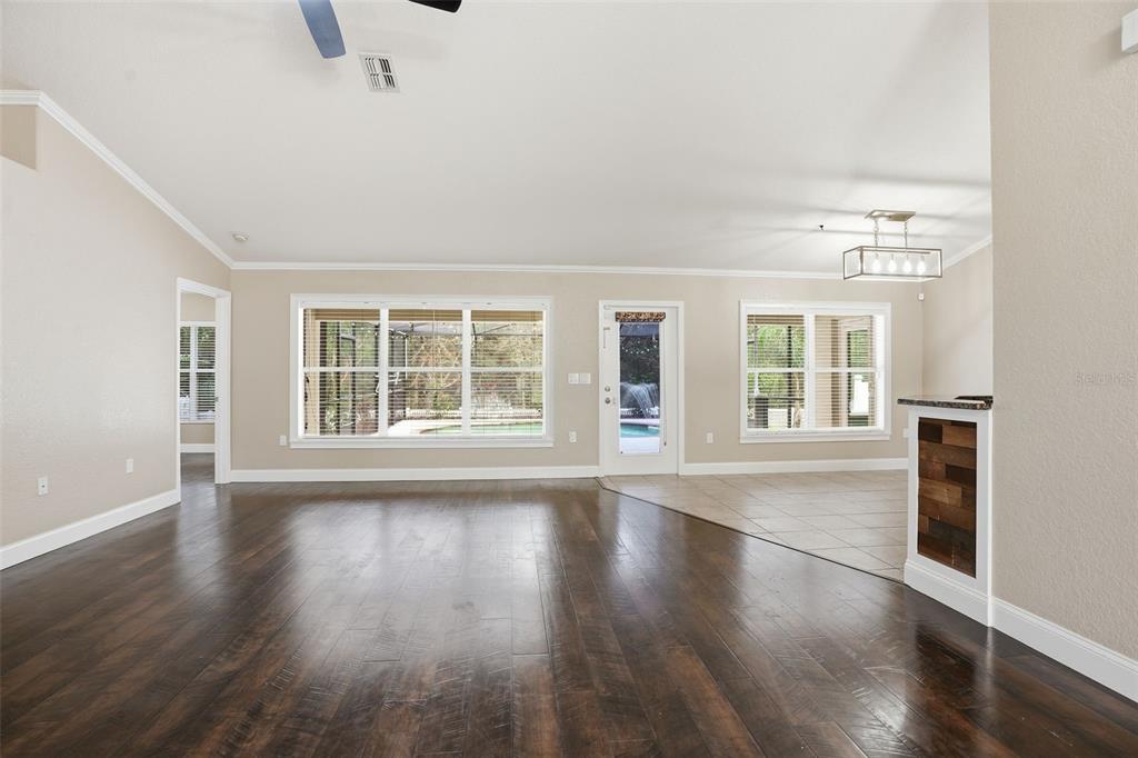26 Statice Court Homosassa, FL 34446 - Photo 11 of 70 a view of an empty room with wooden floor and a window