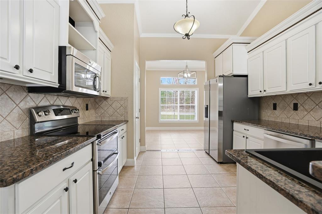 26 Statice Court Homosassa, FL 34446 - Photo 15 of 70 a kitchen with stainless steel appliances granite countertop a stove sink and cabinets