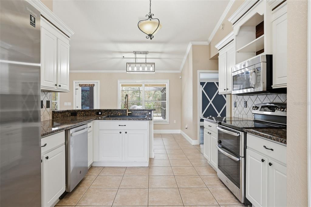 26 Statice Court Homosassa, FL 34446 - Photo 16 of 70 a kitchen with stainless steel appliances granite countertop a stove and a sink
