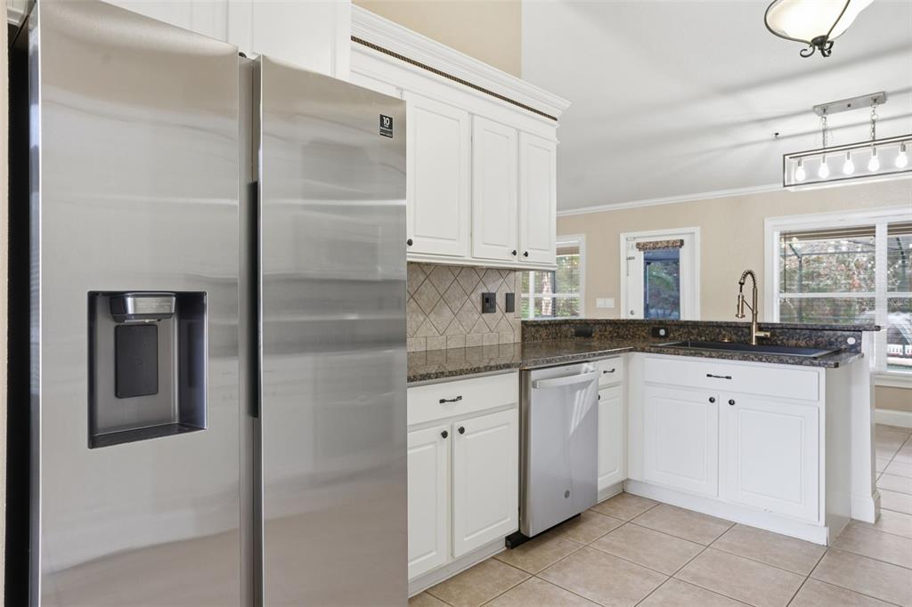 26 Statice Court Homosassa, FL 34446 - Photo 17 of 70 a kitchen with white cabinets and refrigerator