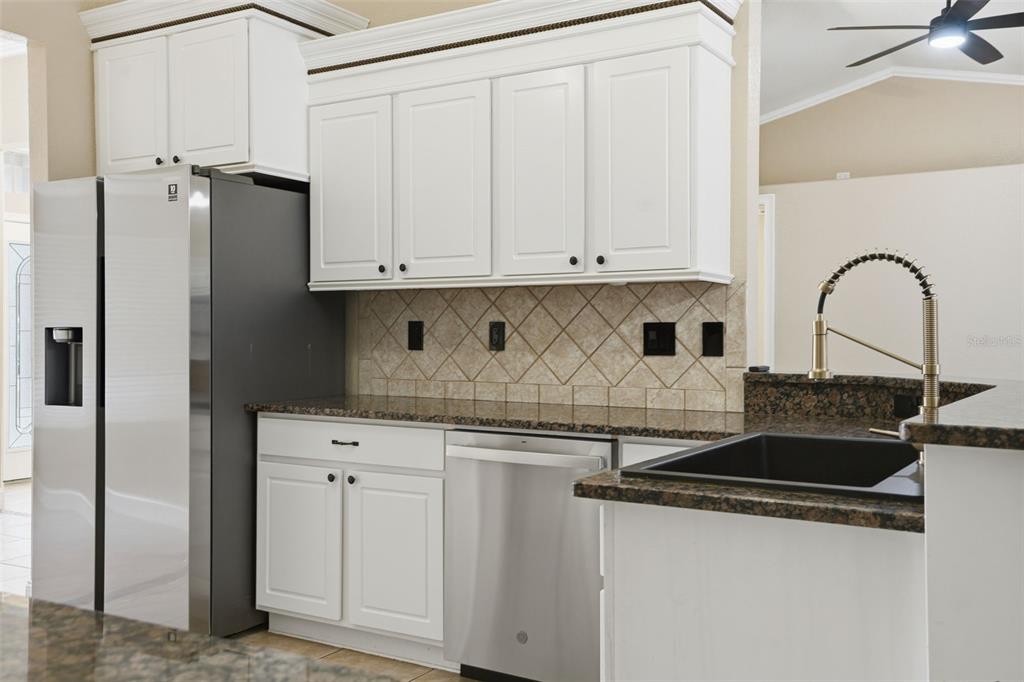 26 Statice Court Homosassa, FL 34446 - Photo 19 of 70 a kitchen with stainless steel appliances granite countertop a sink stove and refrigerator