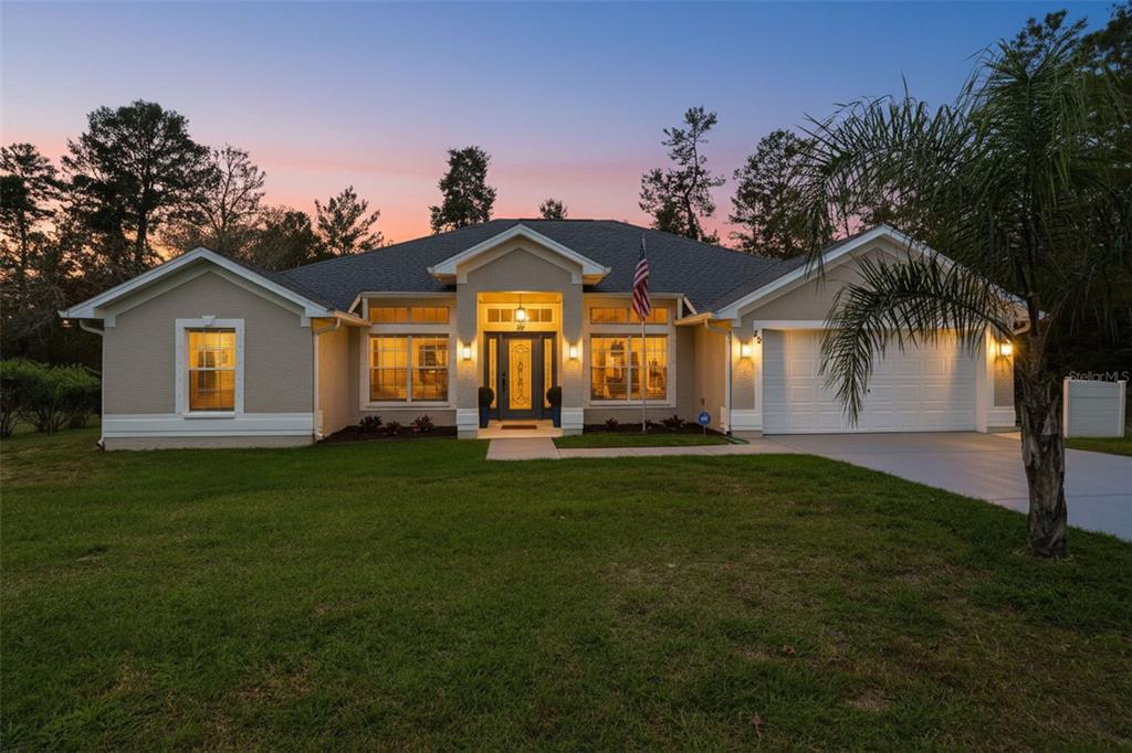 26 Statice Court Homosassa, FL 34446 - Photo 2 of 70 a front view of a house with a garden