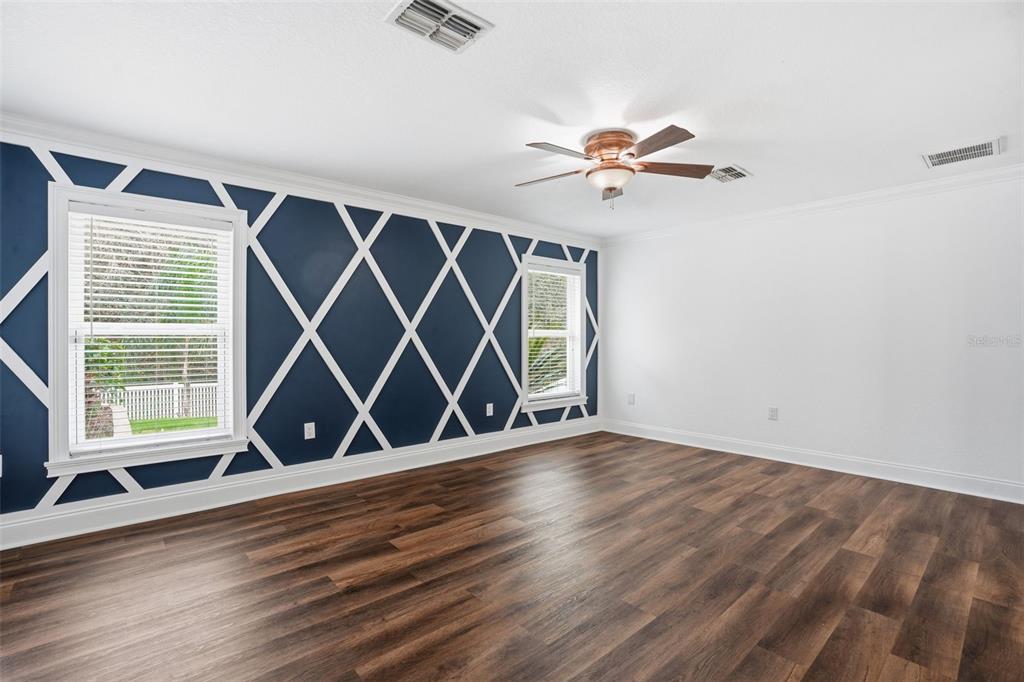 26 Statice Court Homosassa, FL 34446 - Photo 29 of 70 an empty room with wooden floor chandelier fan and windows