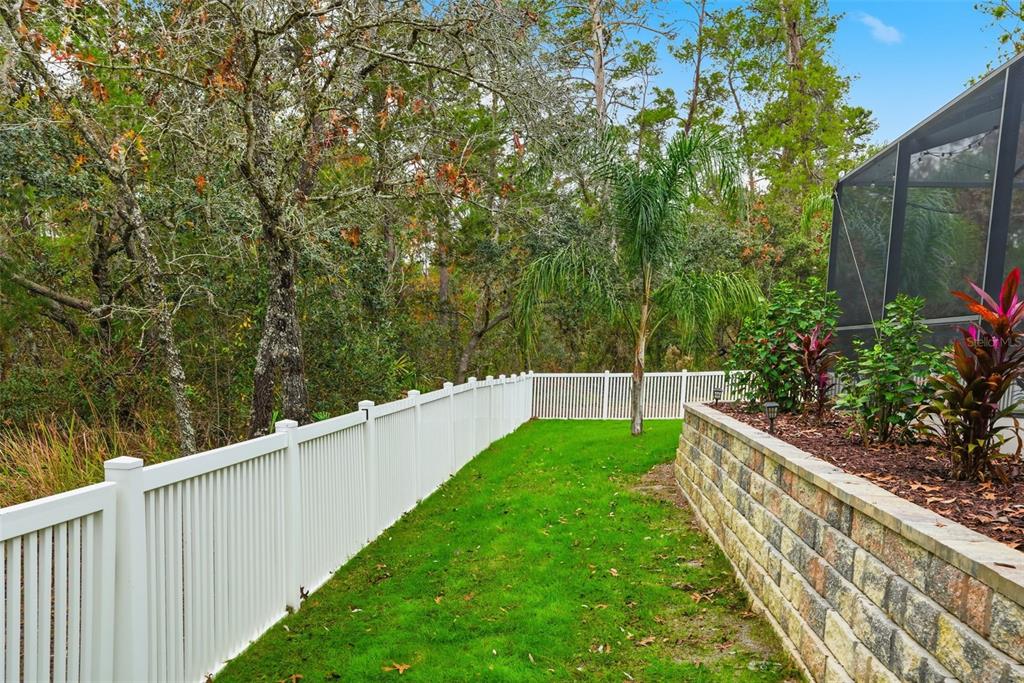 26 Statice Court Homosassa, FL 34446 - Photo 57 of 70 a view of a backyard with potted plants and wooden fence