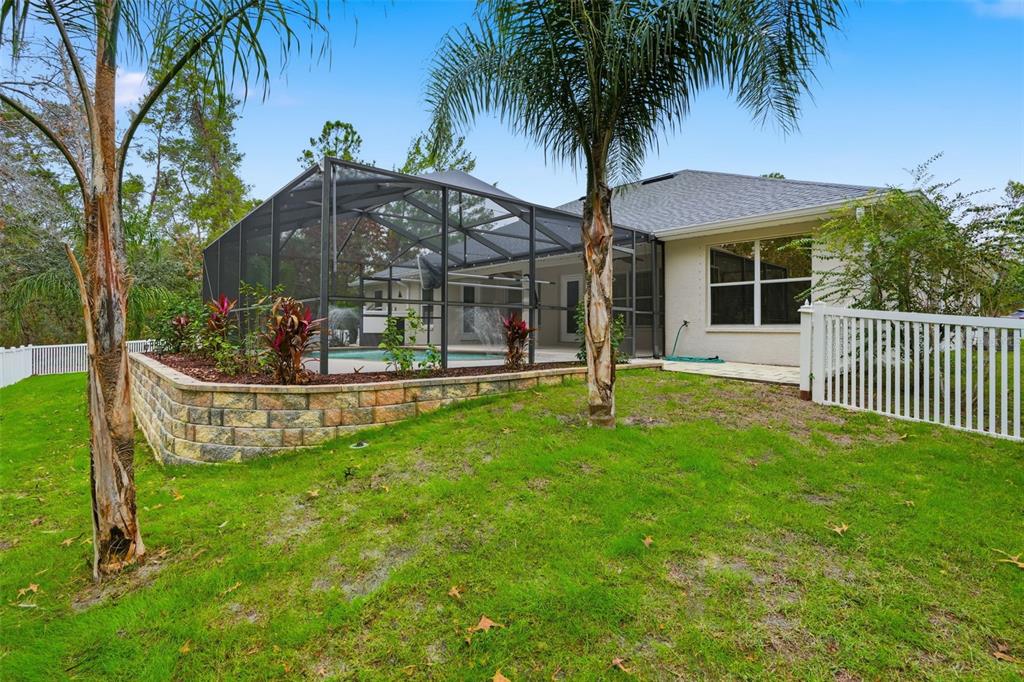 26 Statice Court Homosassa, FL 34446 - Photo 58 of 70 a view of a house with backyard and a garden