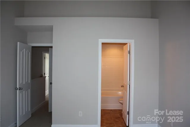 a view of a room with wooden floor and fan