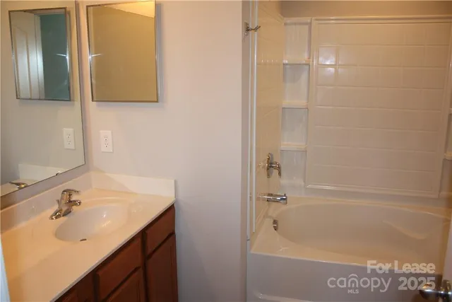 a bath room with a sink and a bath tub
