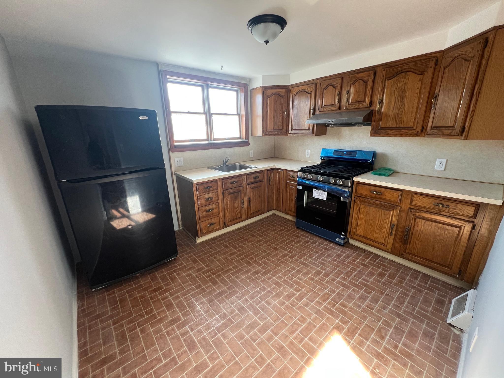 2056 Robbins Street Philadelphia, PA 19149 - Photo 4 of 9 a kitchen with a stove a refrigerator and a sink