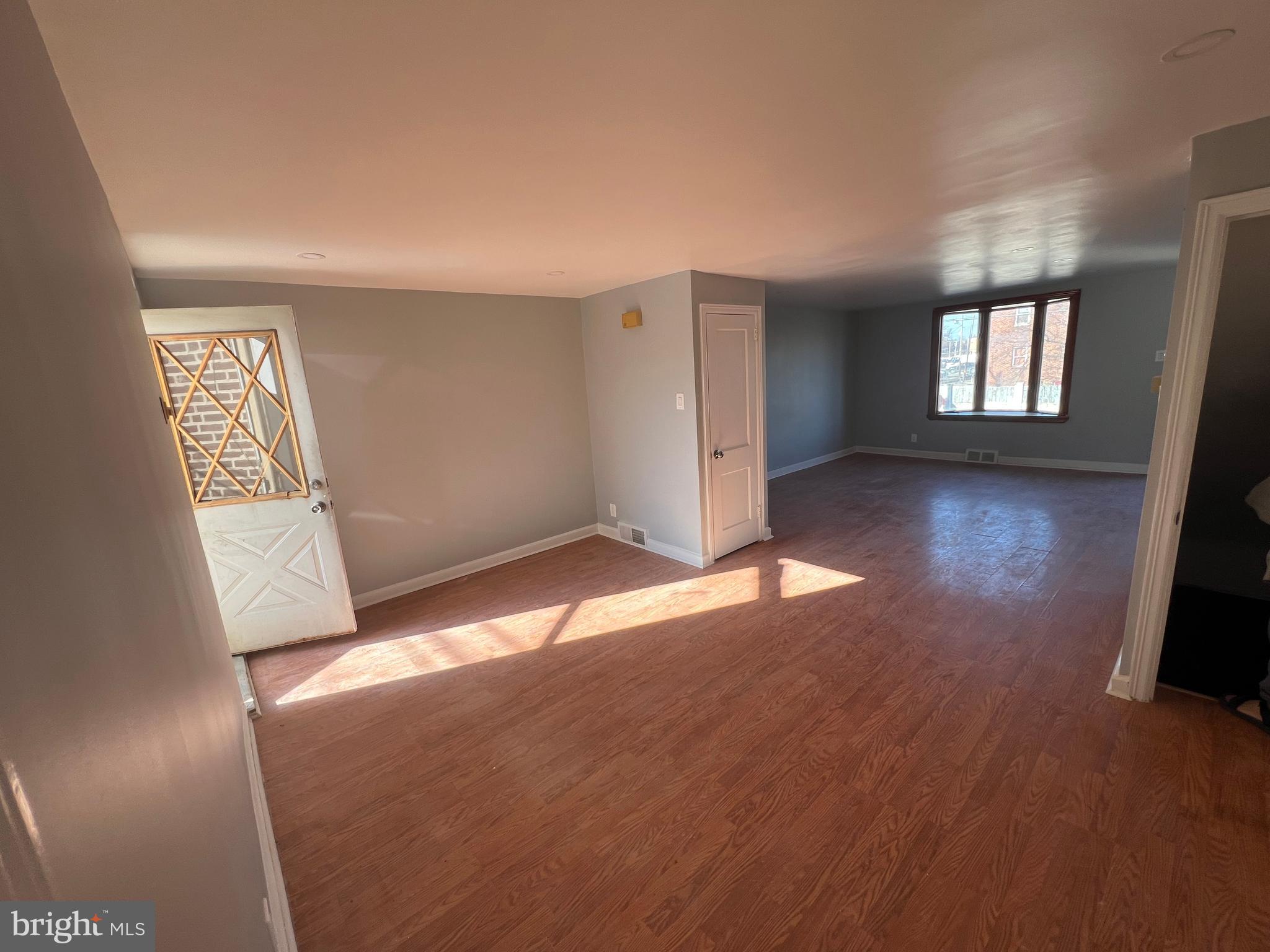 2056 Robbins Street Philadelphia, PA 19149 - Photo 8 of 9 an empty room with wooden floor and windows