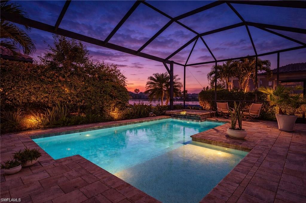 8667 Amour Court Naples, FL 34119 - Photo 39 of 47 Outdoor pool featuring an in-ground hot tub, glass enclosure, a patio, and a sunroom