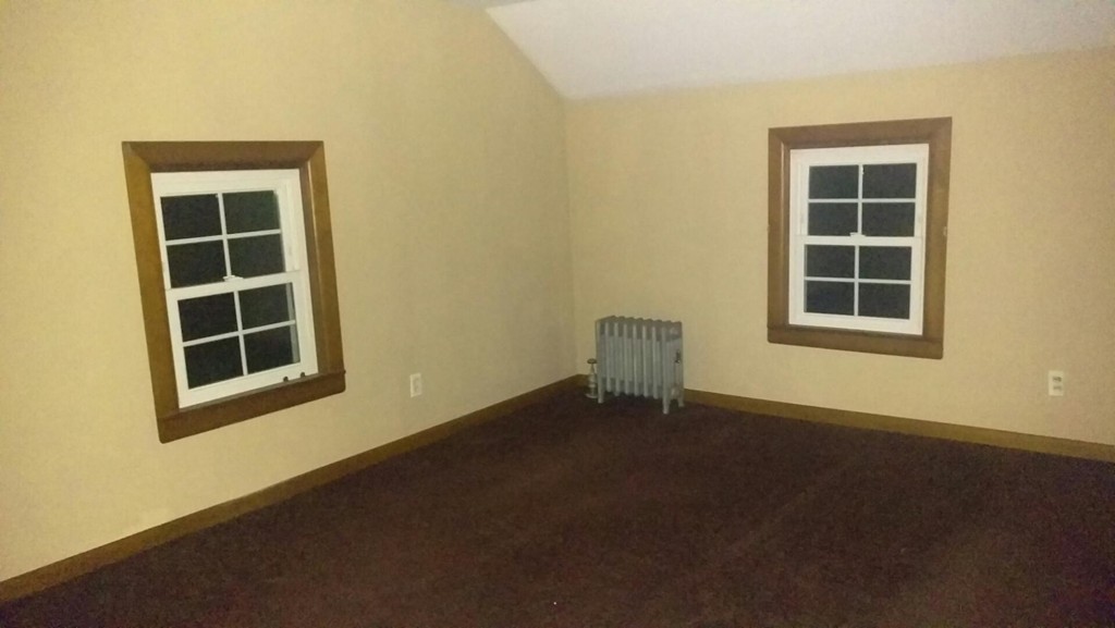 339 Abbe Road Enfield, CT 06082 - Photo 9 of 14 a view of an empty room with a window and wooden floor