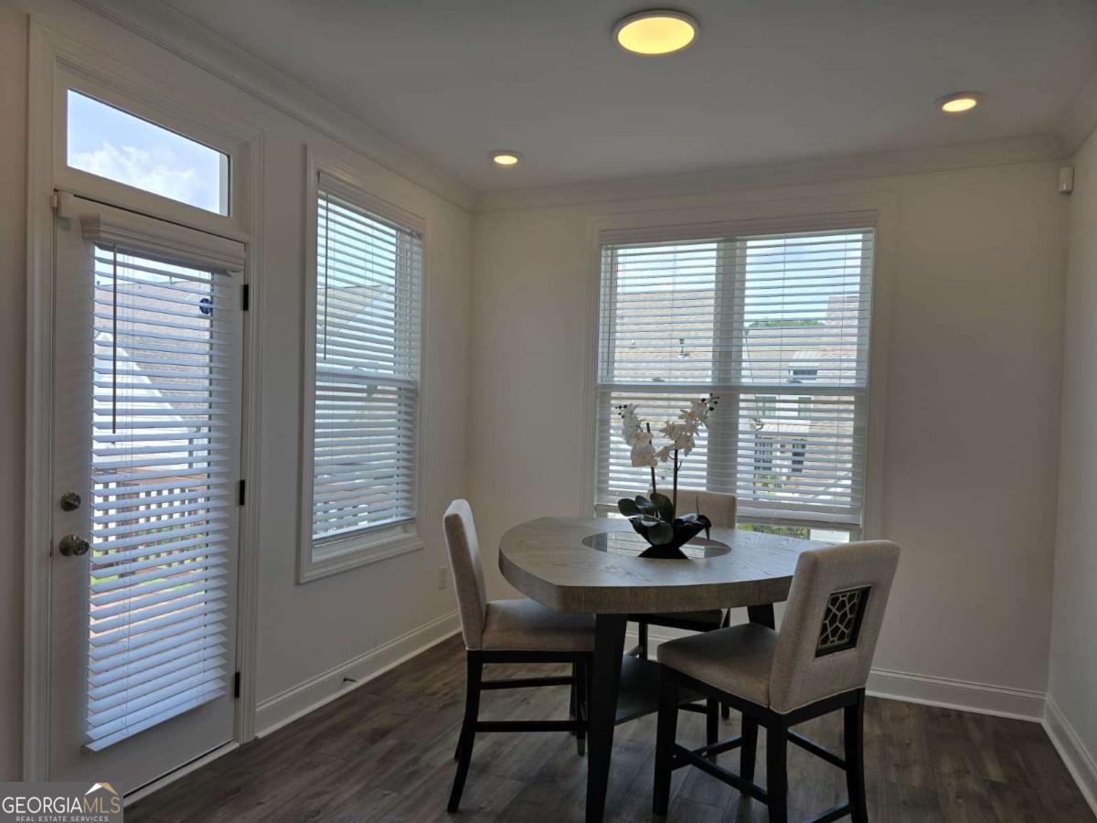 825 Green Sapling Trail, Unit 18 Suwanee, GA 30024 - Photo 13 of 44 a dining room with furniture and window
