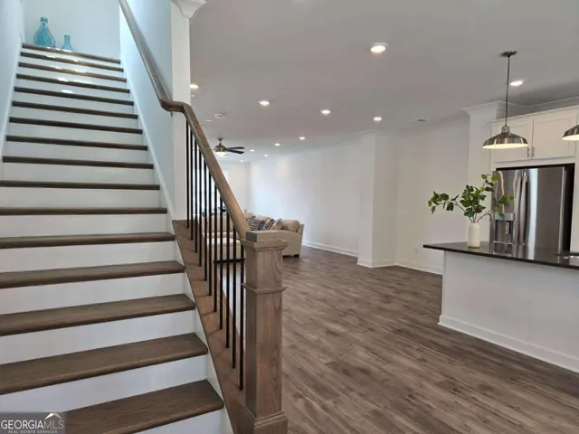 a living room with a bed furniture and a large window