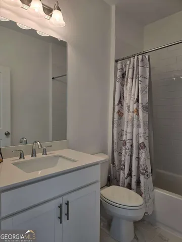 a spacious bedroom with a bed and a window