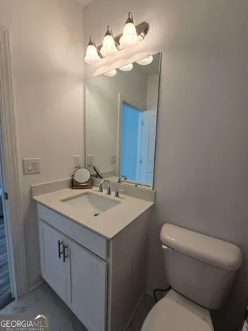 a view of a room with wooden floor and small window