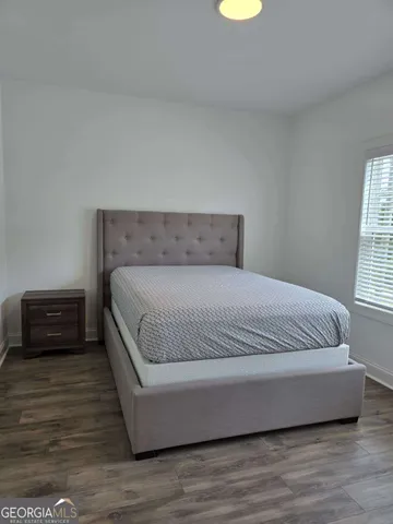 a bedroom with a bed and window