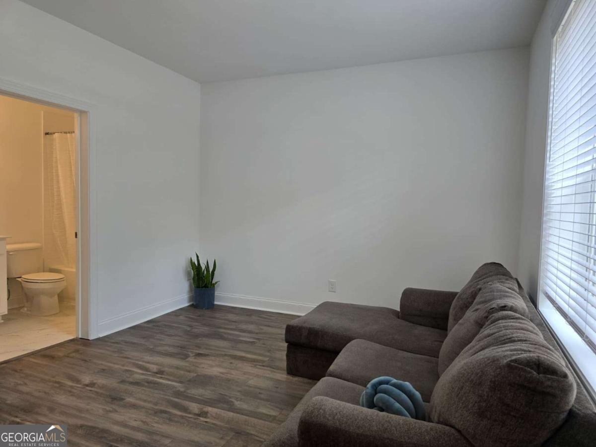 825 Green Sapling Trail, Unit 18 Suwanee, GA 30024 - Photo 34 of 44 a living room with furniture and a potted plant