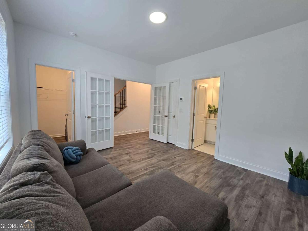 825 Green Sapling Trail, Unit 18 Suwanee, GA 30024 - Photo 35 of 44 a view of a livingroom with a couch