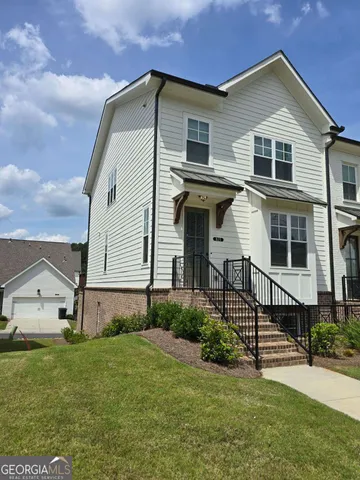 a front view of a house with garden