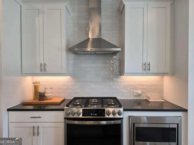 a stove top oven sitting inside of a kitchen