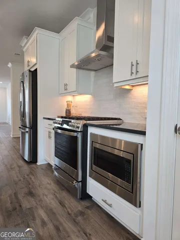 a kitchen with stainless steel appliances a stove a microwave and a refrigerator